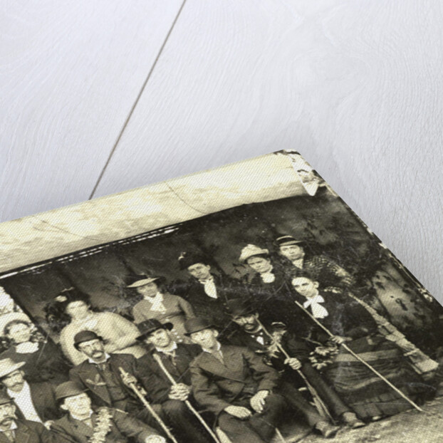 Group portrait of hikers in a makeshift studio by Anonymous
