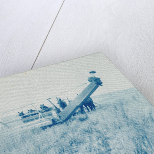 Farmers in a combine harvester, waiting laadkar by Anonymous