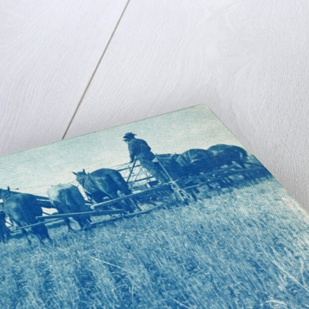 Farmers with a combine harvester pulled by horses by Anonymous