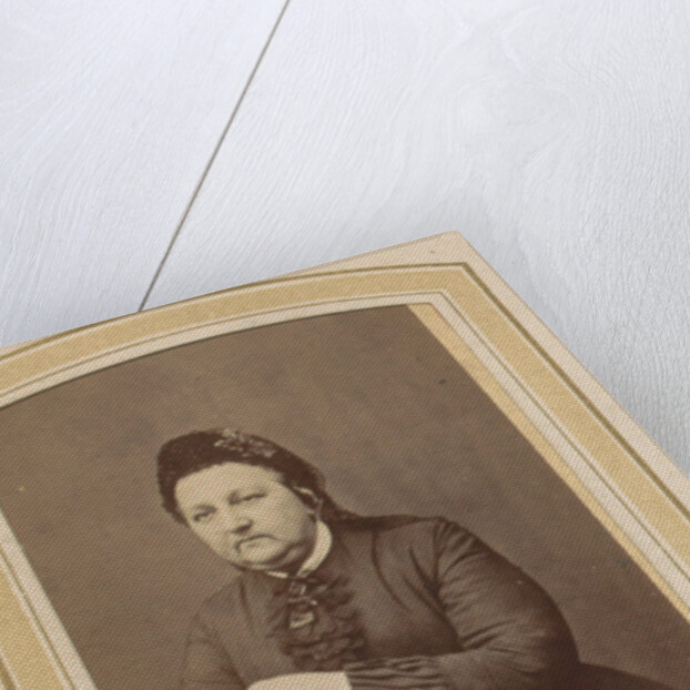 Portrait of a woman with a hat leaning on an armchair by Johannes H. Kramer