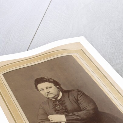 Portrait of a woman with a hat leaning on an armchair by Johannes H. Kramer