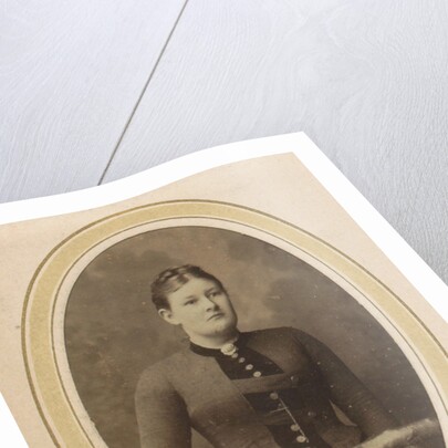 Portrait of a woman with upswept hair, a jacket with buttons and an ornament by J.H. van der Laag