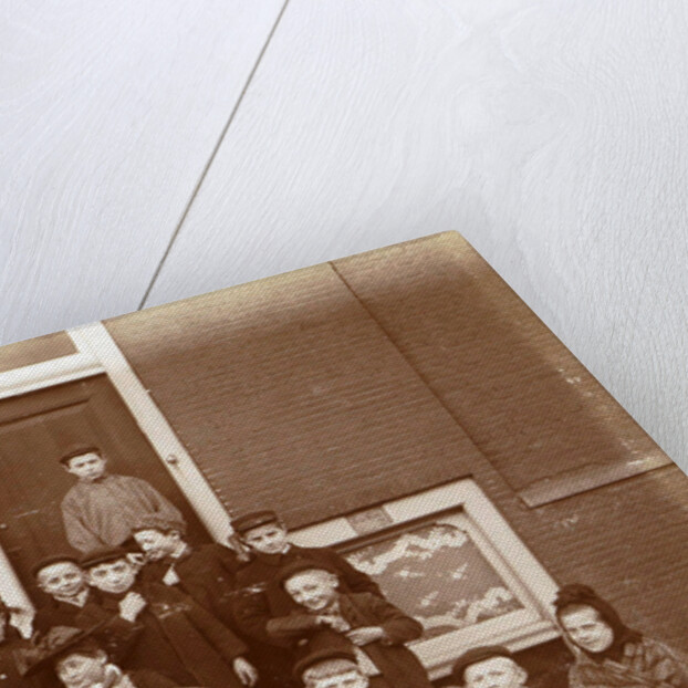 Group of children posing on stairs for entrance doors by Anonymous