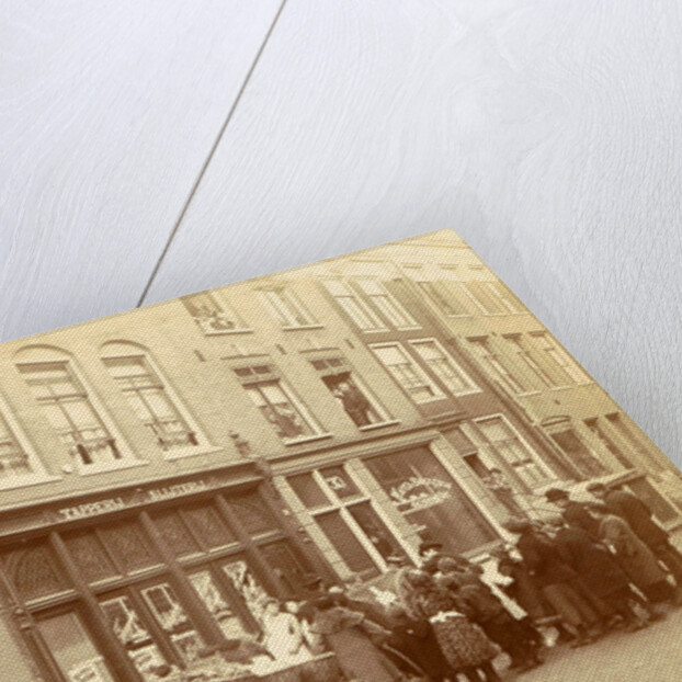 Children and adults watch the work for a liquor store and waffle bakery Jac. van der Zee by Anonymous