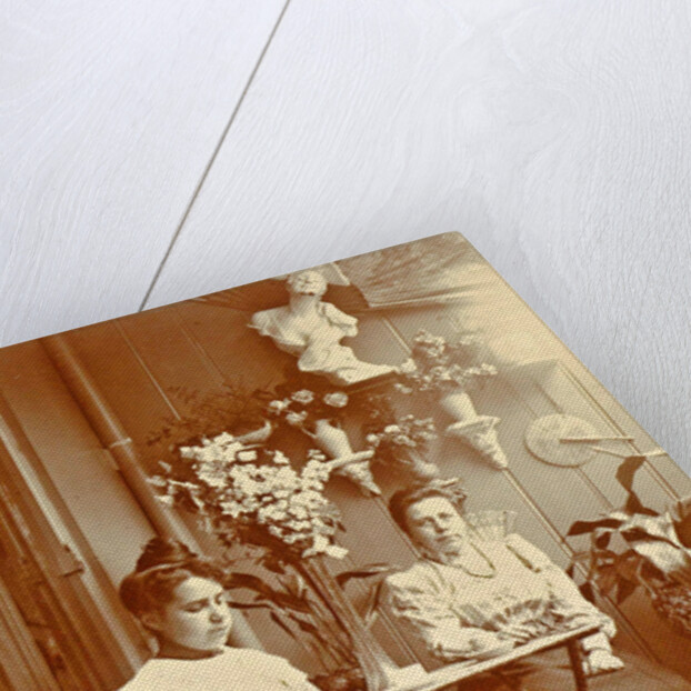 Two women sitting in a greenhouse, one reading by Anonymous