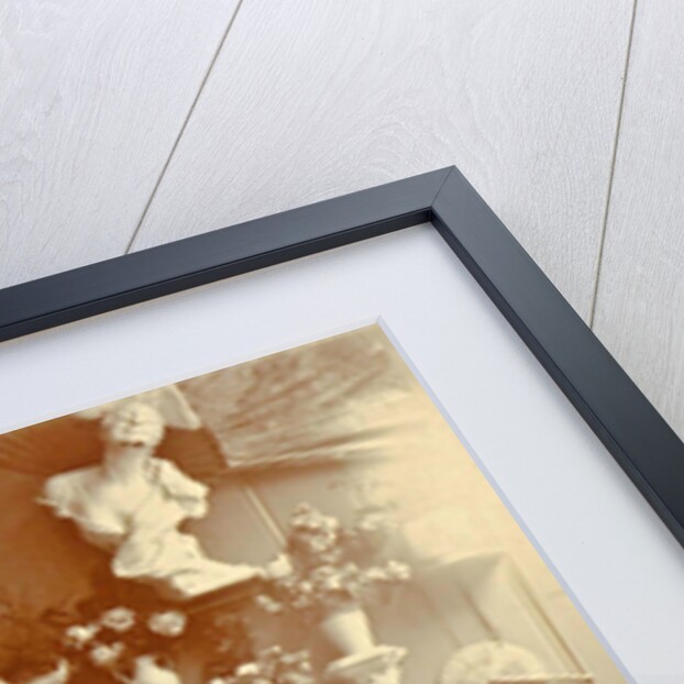 Two women sitting in a greenhouse, one reading by Anonymous