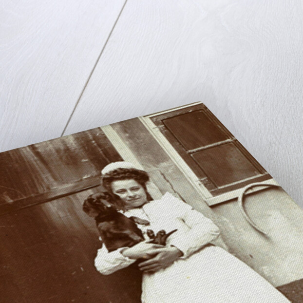 Maid with a dachshund in her arms at an outside tap by Anonymous