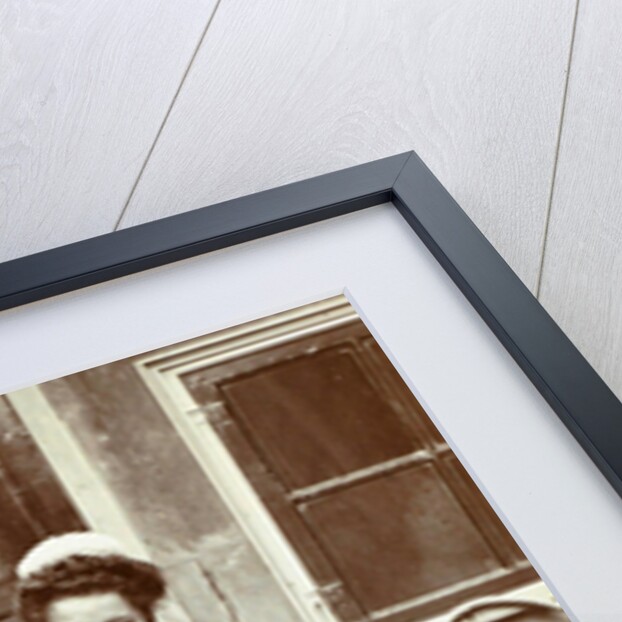 Maid with a dachshund in her arms at an outside tap by Anonymous