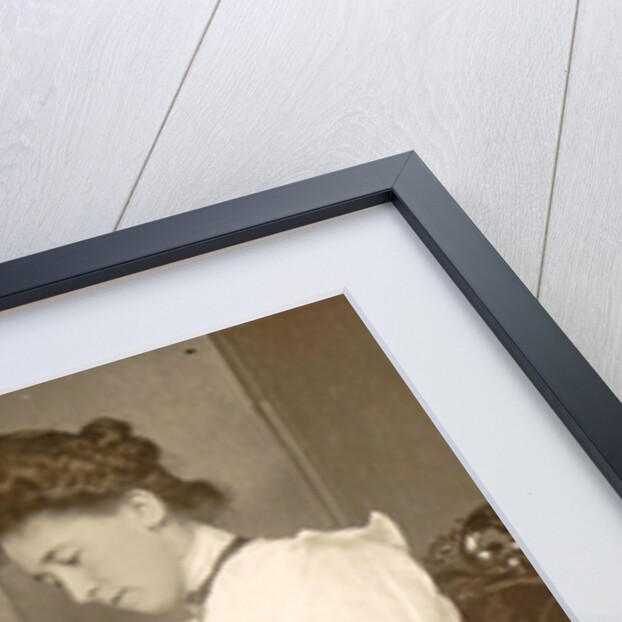 Book Reading woman sitting at a table with a vase of flowers by Anonymous