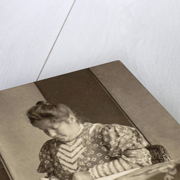 woman writing at a table by Anonymous