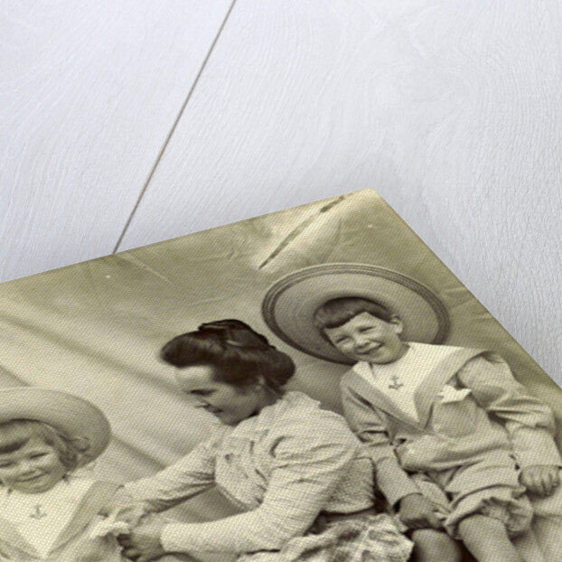 Portrait of a woman with two children with sun hats and sailor suits by Anonymous