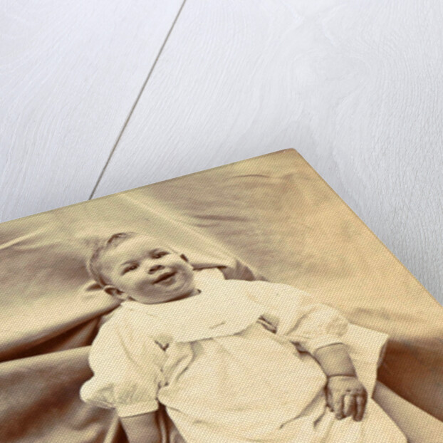 Portrait of a young child in a shirt with lace-up boots by Anonymous