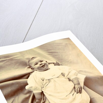Portrait of a young child in a shirt with lace-up boots by Anonymous