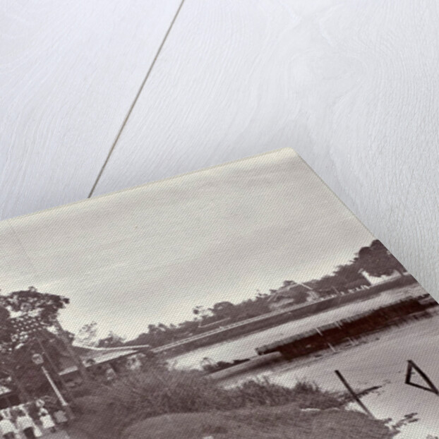 Hikers on a riverbank in Surabaya and in the background the Goebengbrug, Indonesia by Anonymous