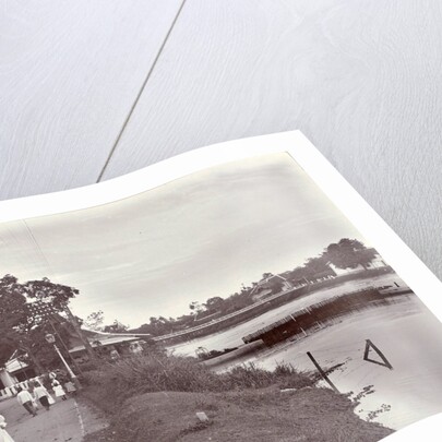 Hikers on a riverbank in Surabaya and in the background the Goebengbrug, Indonesia by Anonymous