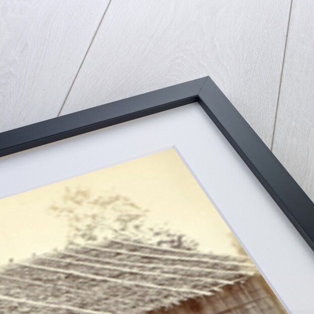 Dutch soldiers sitting in front of a wooden house in the Dutch East Indies by Anonymous