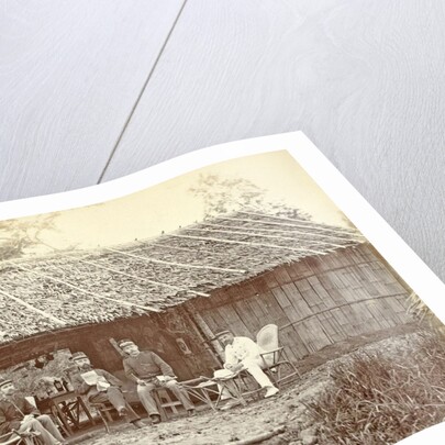 Dutch soldiers sitting in front of a wooden house in the Dutch East Indies by Anonymous