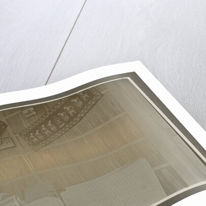 Man sitting at a table by Anonymous