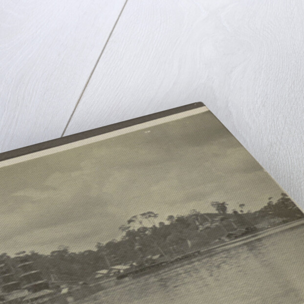 Bank of a village with derricks and buildings seen from the water by Anonymous