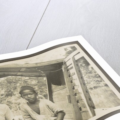 Two Indian boys sitting in roofed wooden boat by Anonymous