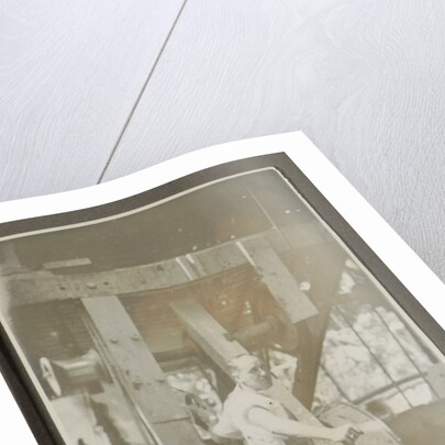 Man operating a machine with a lever by Anonymous