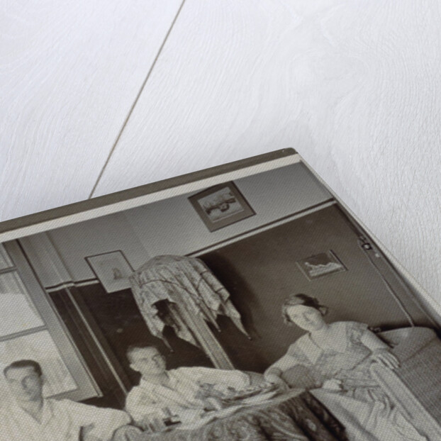 Three men and a woman around a table by Anonymous