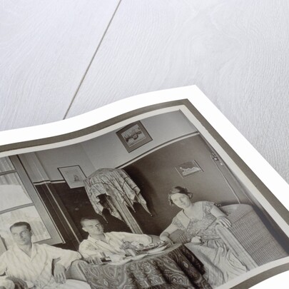 Three men and a woman around a table by Anonymous