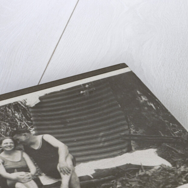 Man and a woman in swimwear on a bench in a forest by Anonymous