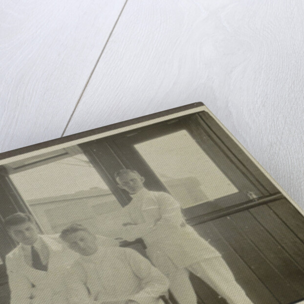 Five men in tropical attire sitting around a table by Anonymous