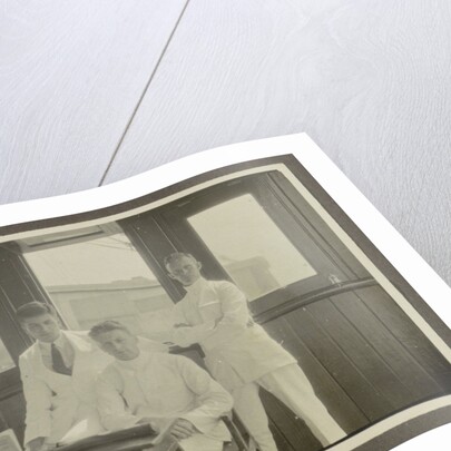 Five men in tropical attire sitting around a table by Anonymous