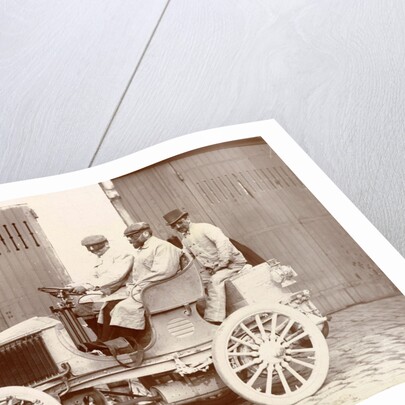 Three men with big sunglasses in an open car by Anonymous