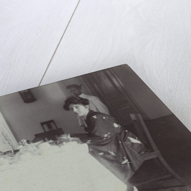 Group portrait of young women at the table with servants in the Dutch East Indies, indonesia by Anonymous