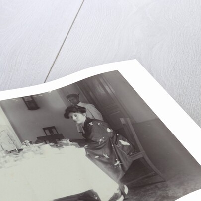 Group portrait of young women at the table with servants in the Dutch East Indies, indonesia by Anonymous