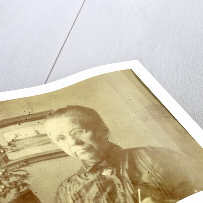 Portrait of an old lady with glasses in a living room by Anonymous