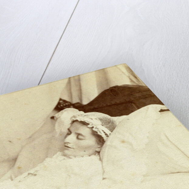 Post mortem portrait of a deceased woman; she is wearing a hat and holding a bunch of roses and a rosary between her clasped hands by Anonymous