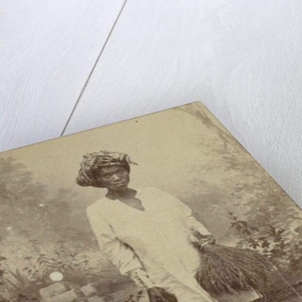 Studio Portrait of woman with paddy in her hand by Anonymous