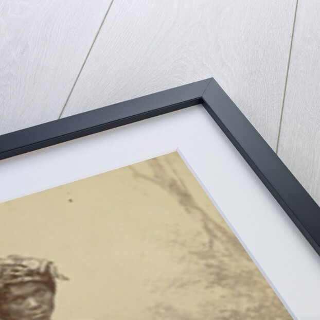 Studio Portrait of woman with paddy in her hand by Anonymous