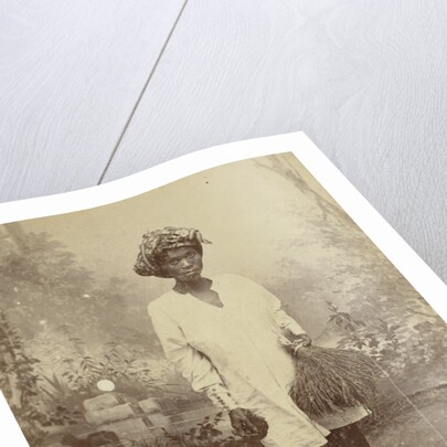 Studio Portrait of woman with paddy in her hand by Anonymous