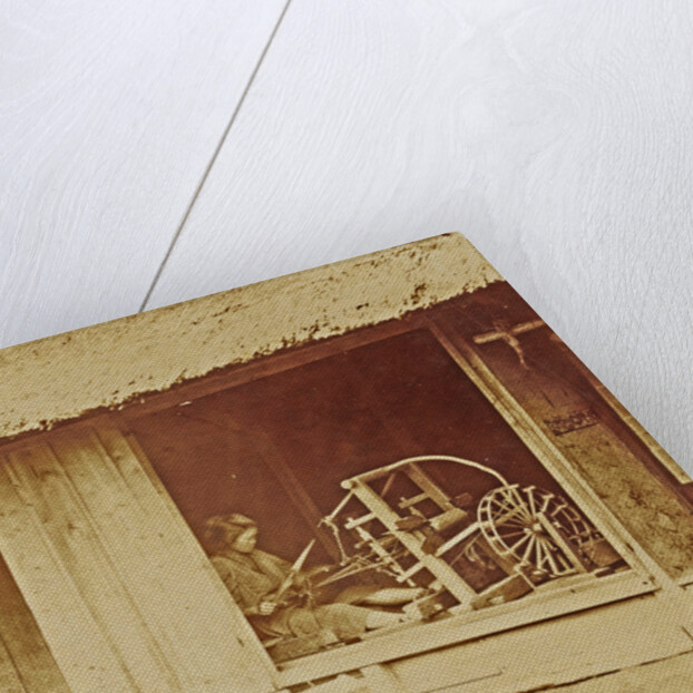 Woman at a loom in a barn by Anonymous
