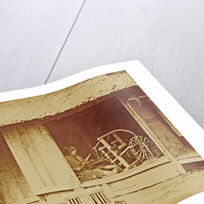 Woman at a loom in a barn by Anonymous