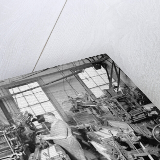 Paterson, New Jersey - Textiles. Weaver operating four-loom system. He is shown removing a used-up quill from the shuttle, 1936 by Lewis Hine