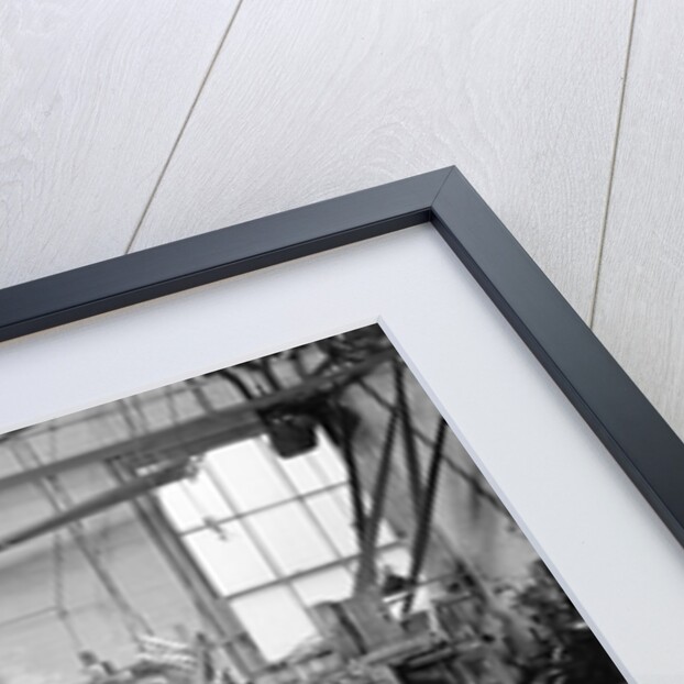 Paterson, New Jersey - Textiles. Weaver operating four-loom system. He is shown removing a used-up quill from the shuttle, 1936 by Lewis Hine