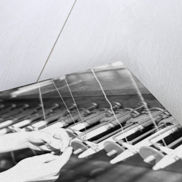 Paterson, New Jersey - Textiles. Quiller tying the broken ends of thread being wound on to quills, March 1937 by Lewis Hine