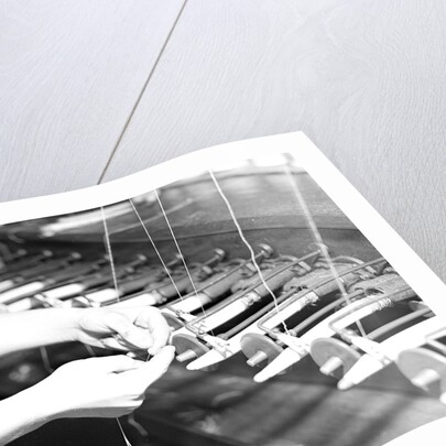 Paterson, New Jersey - Textiles. Quiller tying the broken ends of thread being wound on to quills, March 1937 by Lewis Hine