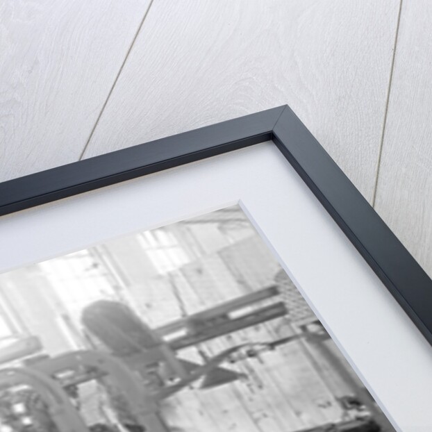 Paterson, New Jersey - Textiles. Idle quilling machines and looms in a cockroach shop. Note partition on the right and chicken-wire in the front, March 1937 by Lewis Hine