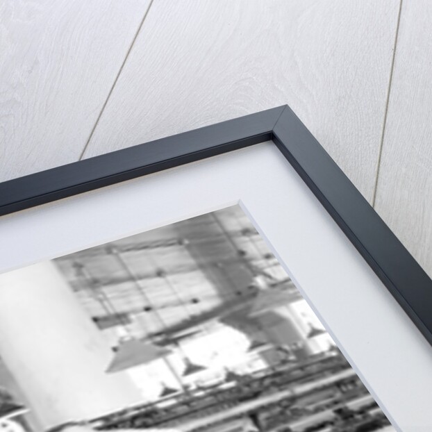 Philadelphia, Pennsylvania - Hosiery. Minnesac Mills. Man working over long row of machines, 1936 by Lewis Hine