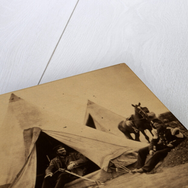 Officer of the 57th Regiment sitting with a sword across his lap at opening to his tent by Roger Fenton