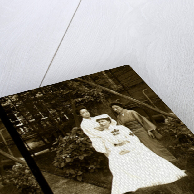 A western Red Cross female doctor(?) and two Japanese women posed in a garden by Anonymous