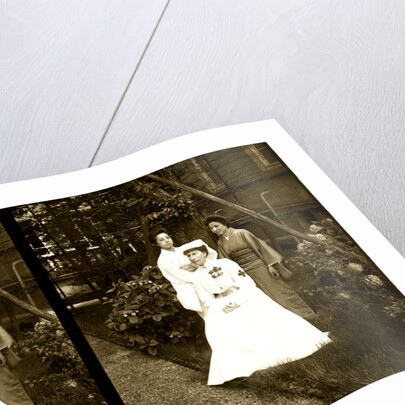 A western Red Cross female doctor(?) and two Japanese women posed in a garden by Anonymous