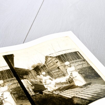 Japanese nurses carrying a patient on a stretcher by Anonymous
